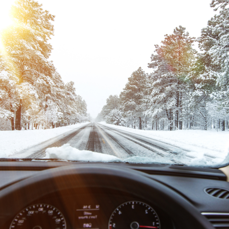 Person driving in the winter sun glare.